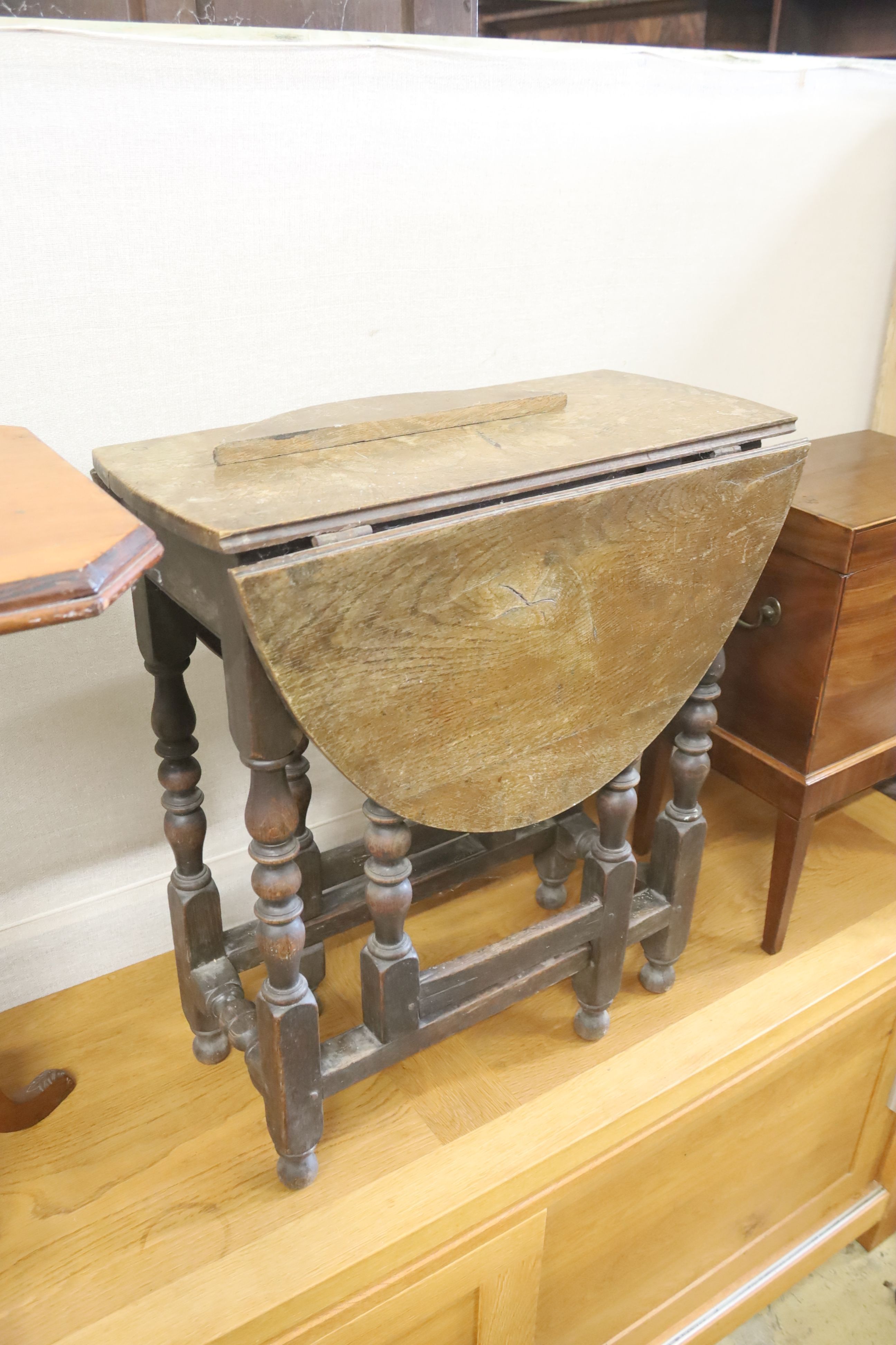 A small 18th century style oak gateleg table, width 60cm, depth 30cm, height 69cm together with a walnut tripod games table
